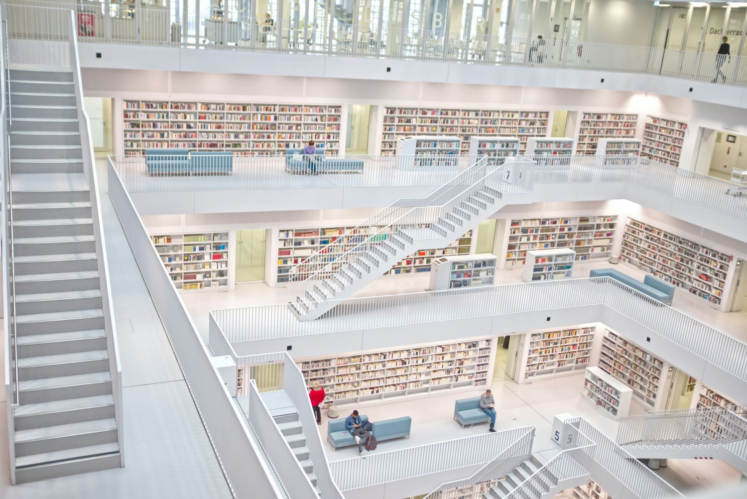 A large white library with multiple levels
